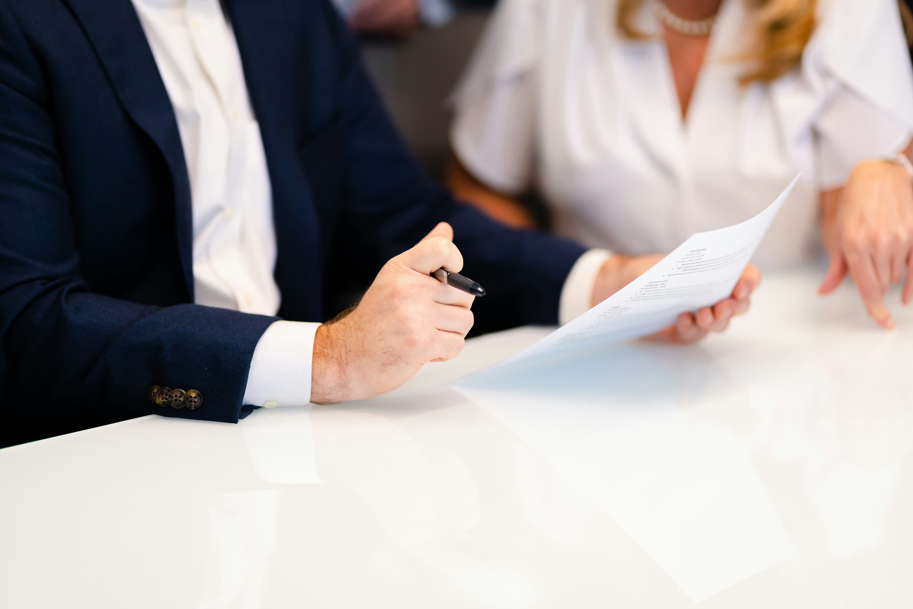 Signing legal documents during a business meeting